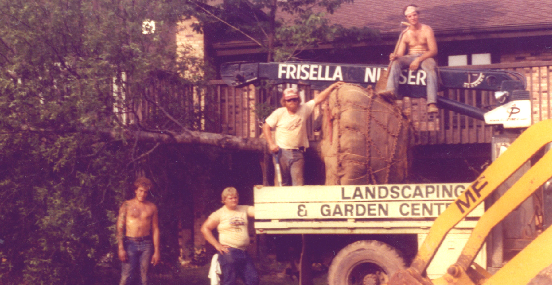 Photo of a vintage truck and Frisella employees hanging out