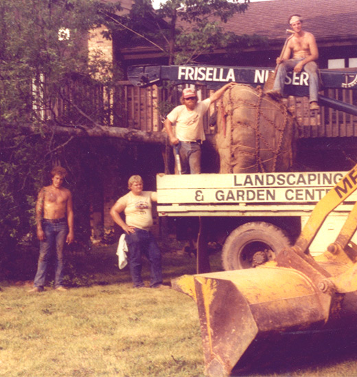Photo of a vintage truck and Frisella employees hanging out